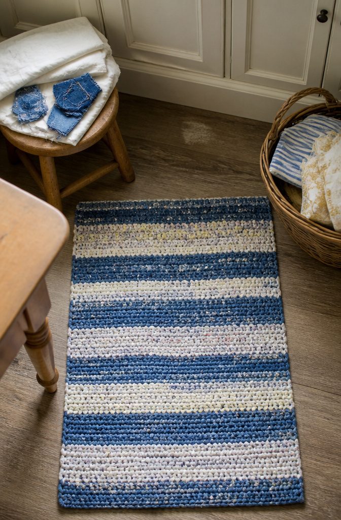 Cotton fabric scraps and denim pieces arranged for rug making
