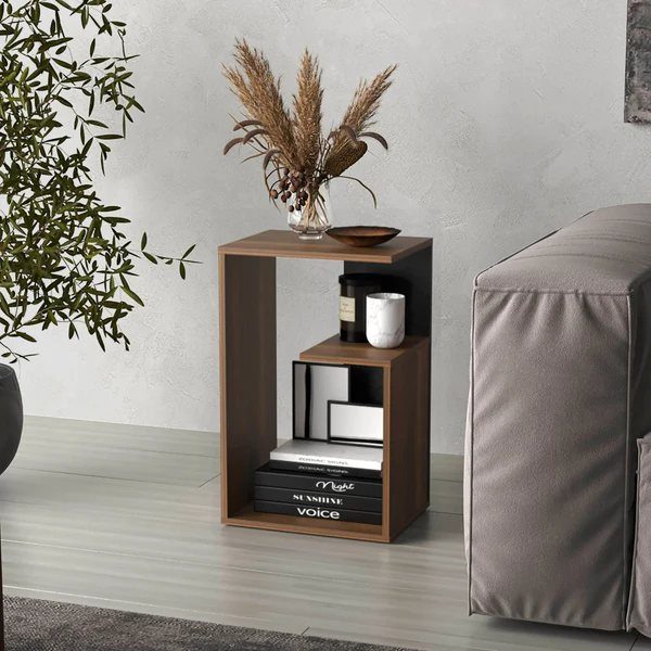 Modern brown wooden end table with shelving next to a grey sofa