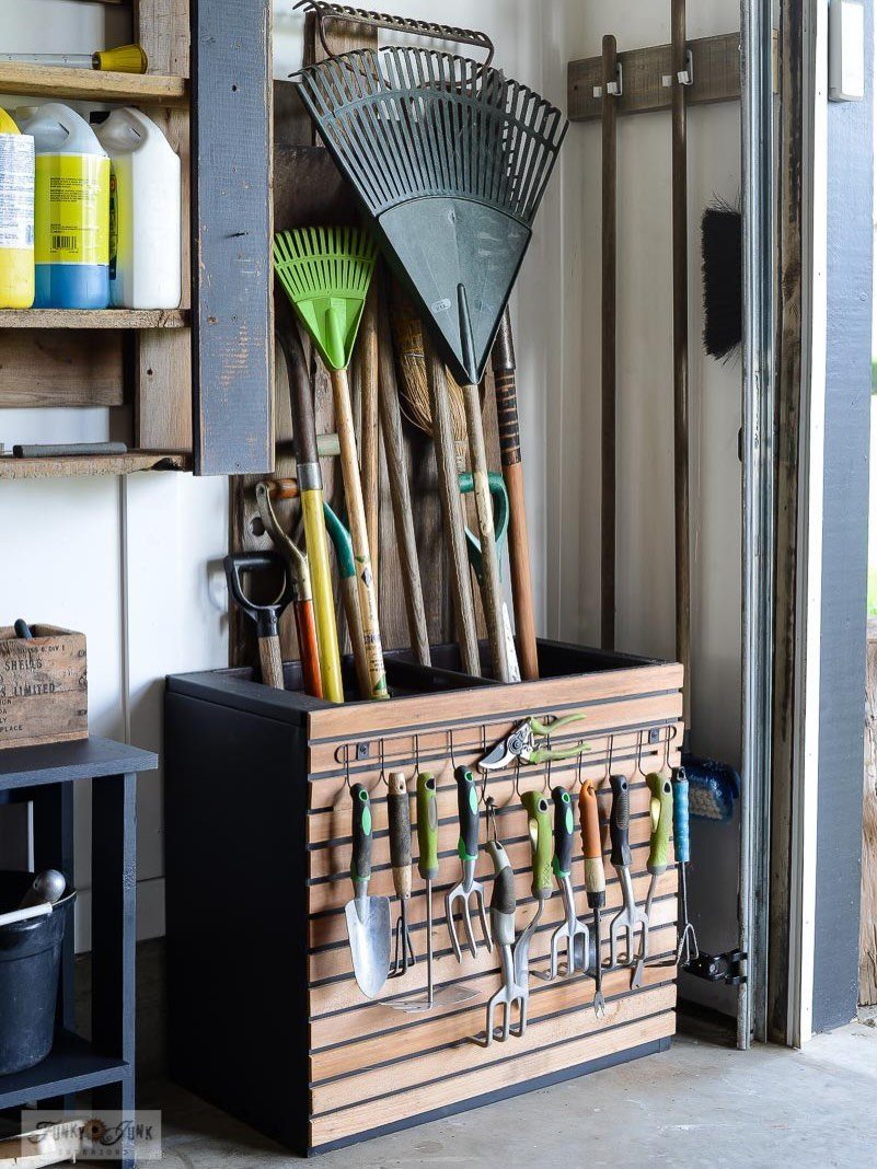 DIY Garage Organization: 17 Ideas to Build and Install 6 Gardening station with long-handled tools in bins and hand tools hanging on wooden slats.