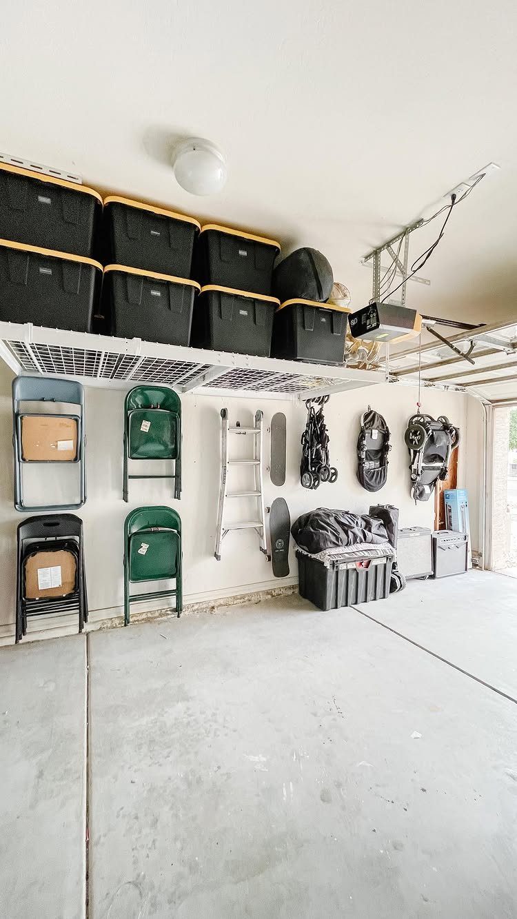 DIY Garage Organization: 17 Ideas to Build and Install 2 Garage interior with black bins on overhead shelves and equipment hanging on walls.