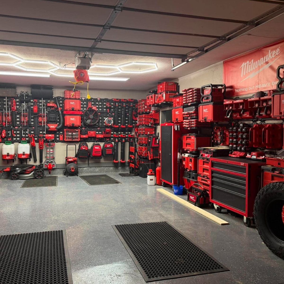 DIY Garage Organization: 17 Ideas to Build and Install 3 Organized garage with red power tools on pegboards and red tool cabinets.