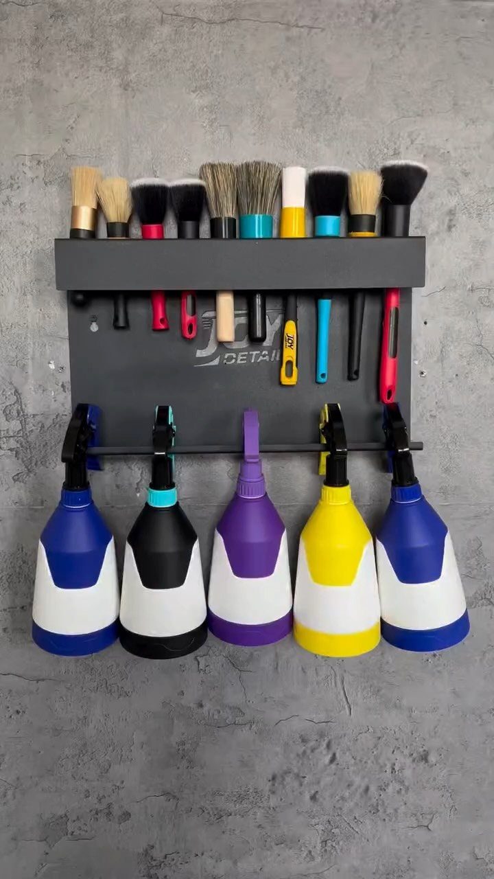DIY Garage Organization: 17 Ideas to Build and Install 13 Wall-mounted organizer with paintbrushes and colorful spray bottles on a grey concrete wall.