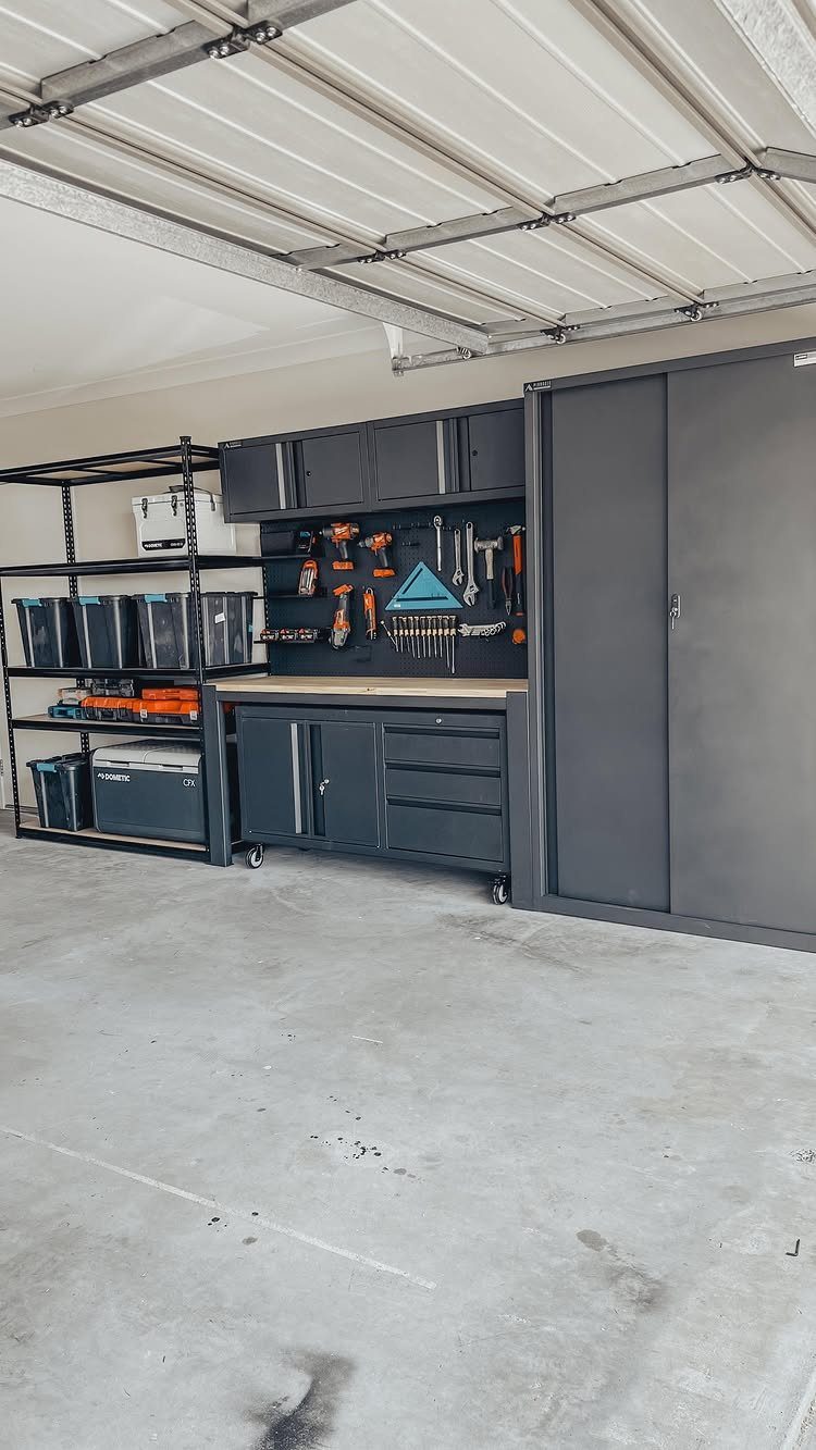 17 Garage Storage Inspiration Ideas to Organize Any Space 5 Grey garage workbench and tool wall with organized hand tools and storage bins.