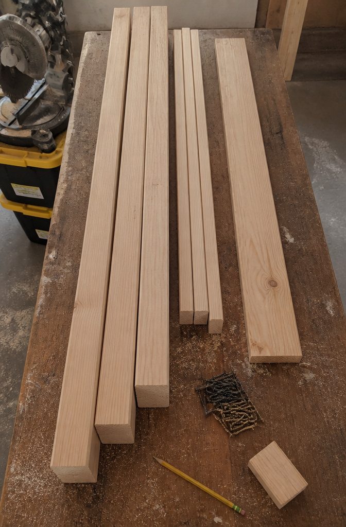 Wood boards and construction screws laid out for a tote rack