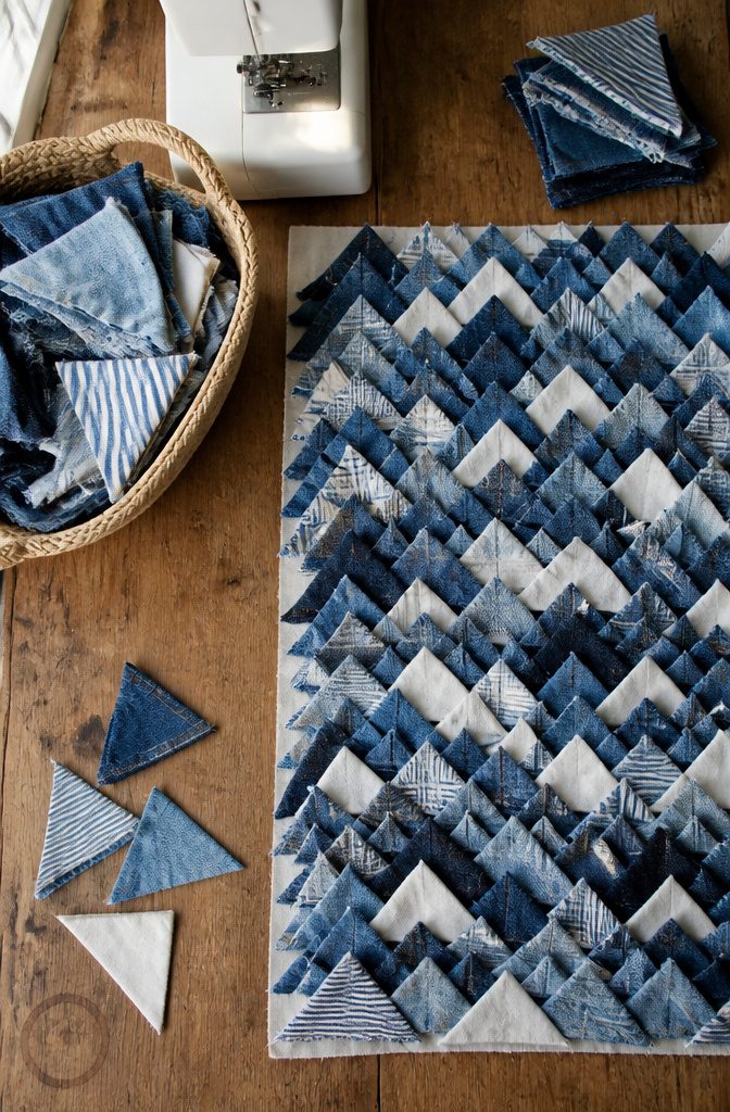 Cut denim pieces arranged in rows with light and dark shades