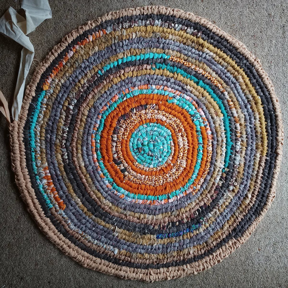 8 Ways to Make a Rag Rug From Braided to Woven 4 Round Amish knot rag rug with colorful concentric circles of fabric strips.