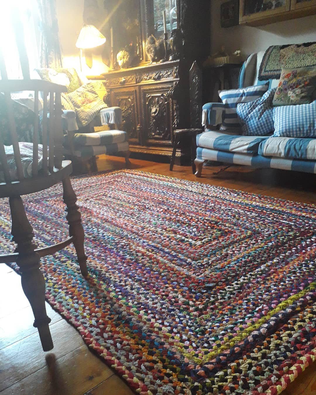 8 Ways to Make a Rag Rug From Braided to Woven 2 Colorful crocheted rag rug on a wooden floor in a cozy living room.