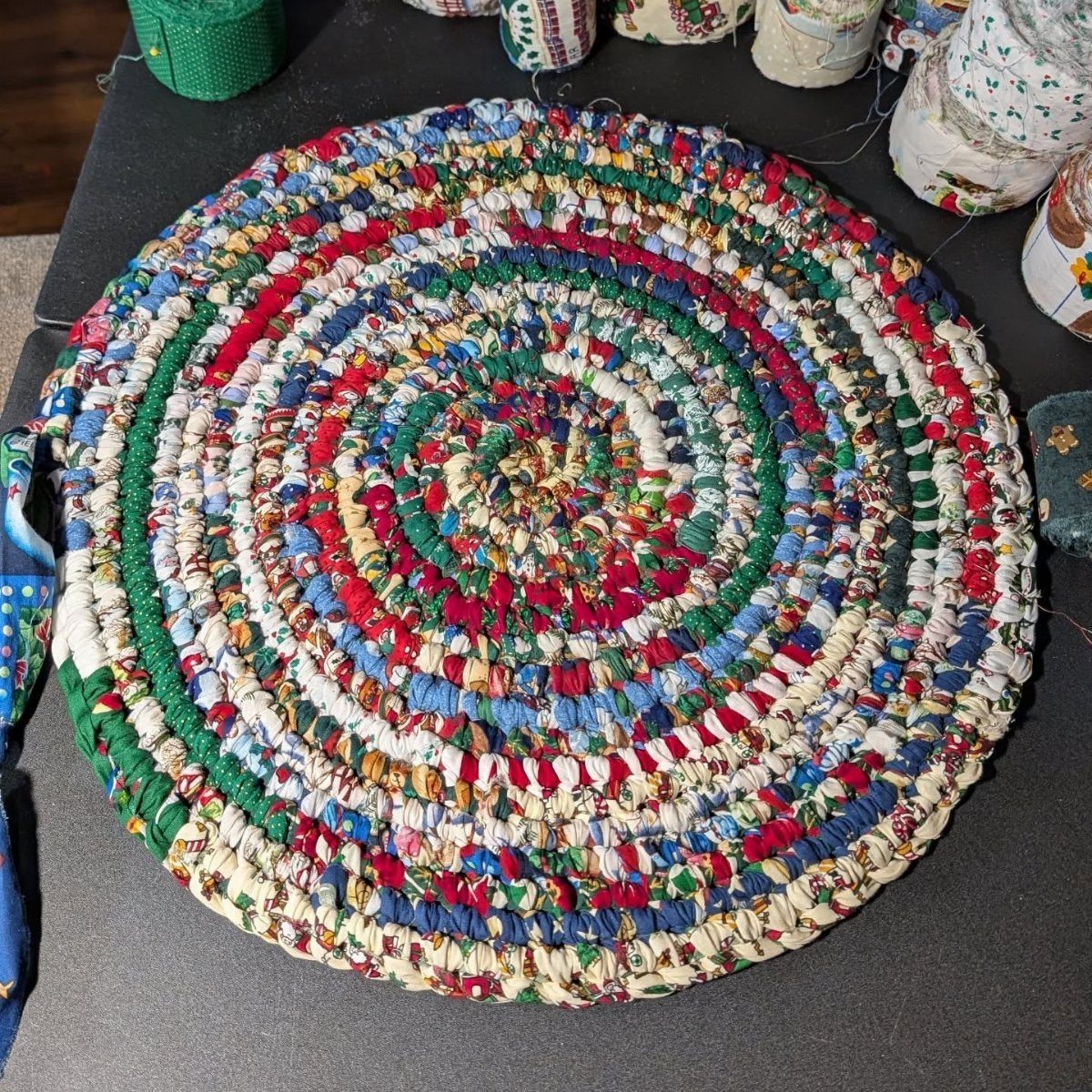8 Ways to Make a Rag Rug From Braided to Woven 6 Circular rag rug made of colorful fabric strips coiled in a spiral pattern.